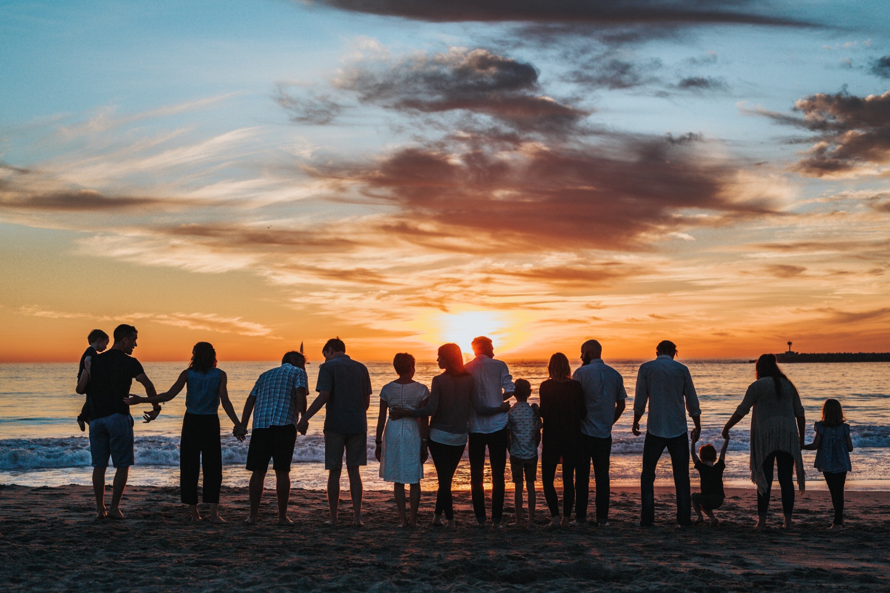 Multi-generational family together at sunset